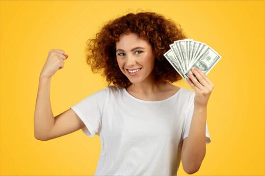 Teen holding cash and making a muscle.